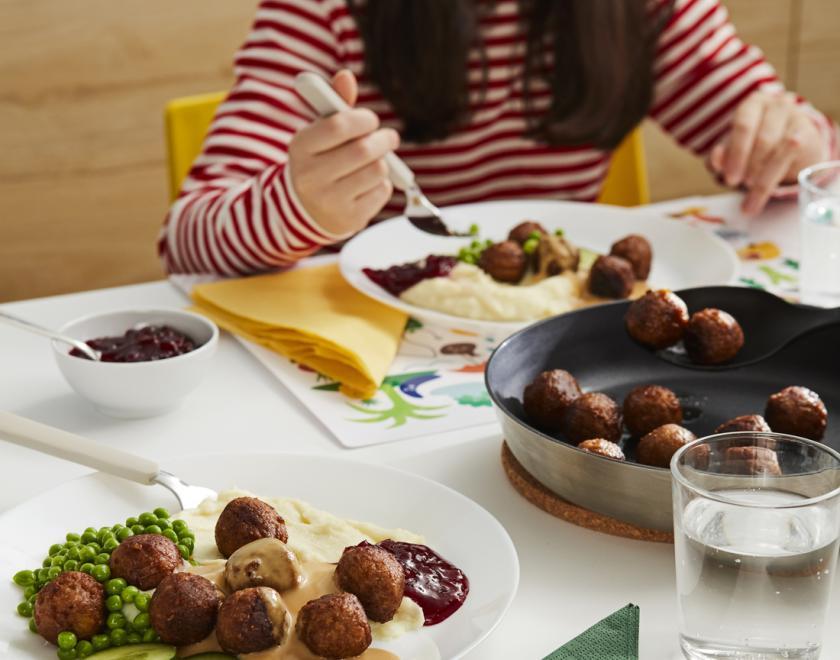 Table set with plates of IKEA Swedish meatballs 