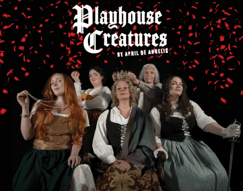 Photo of five women seated together, dressed as characters from the play in 1600s era clothing. Red confetti falls from above, and white text reads 'Playhouse Creatures by April de Angelis'.