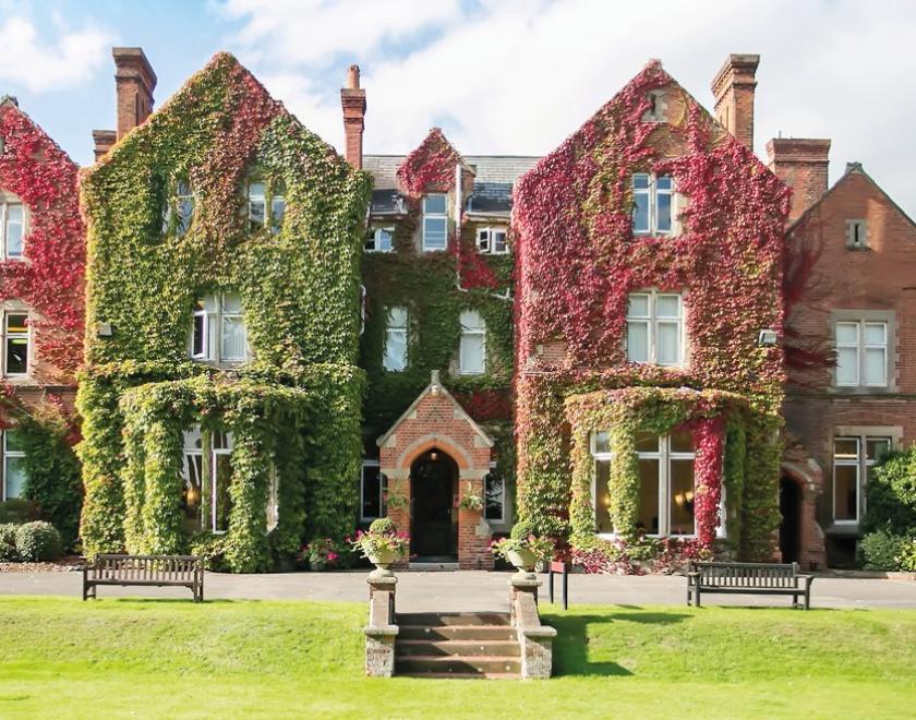 Image of the ivy clad front of Queen Anne's School