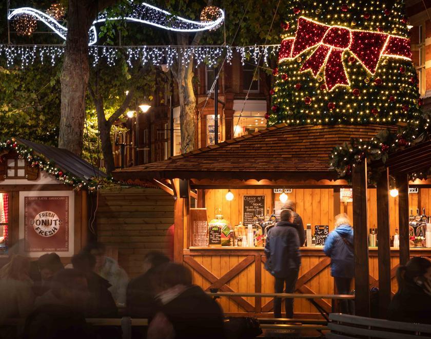 Reading Christmas lights over a street market stall