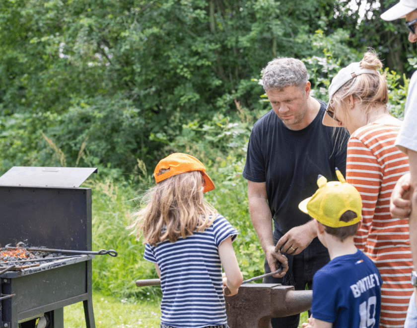 Blacksmith and families in the MERL garden