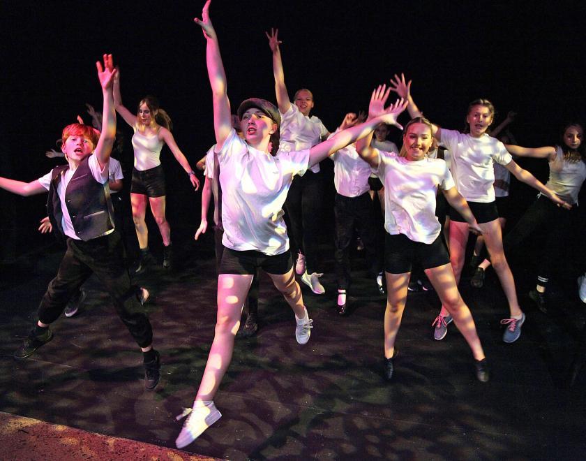 Youth Theatre participants dancing on the Reading Rep stage