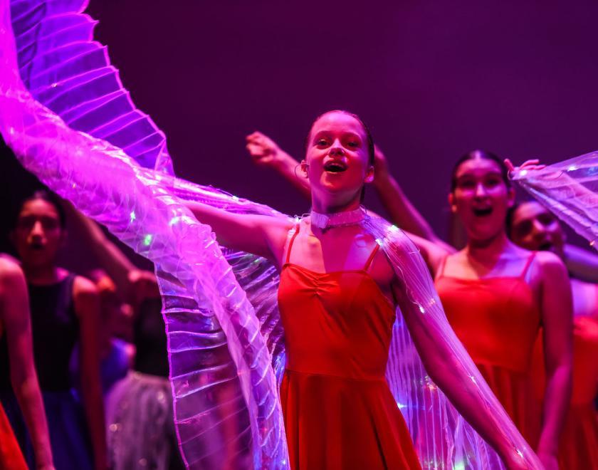 Girl singing and dancing on stage