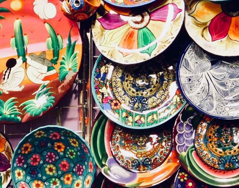 Colourful ceramic plates hanging on the wall