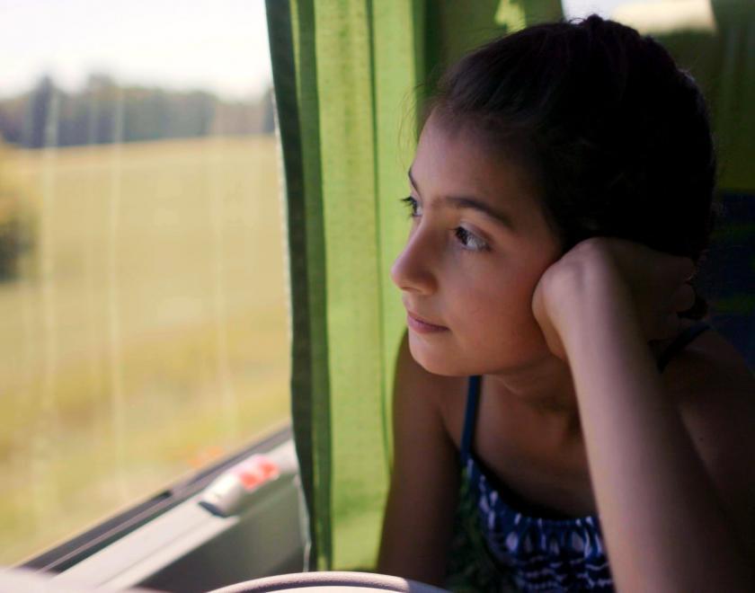 Girl looking out of train window 