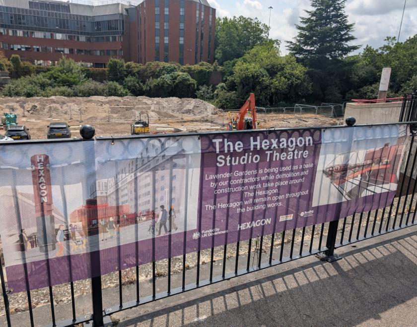 View of the Hexagon theatre building site with a banner informing people about the plans