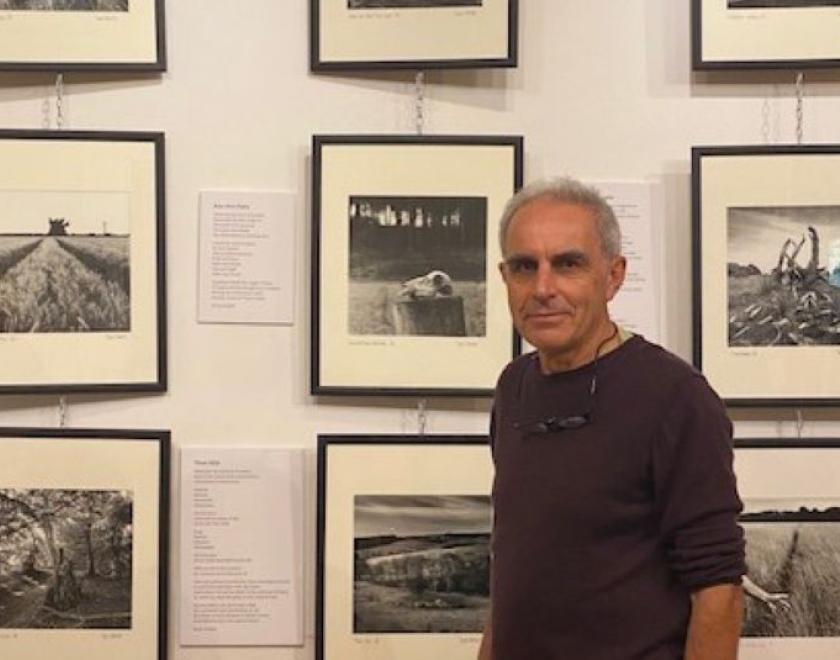David standing in front of his photos in the Progress Theatre foyer