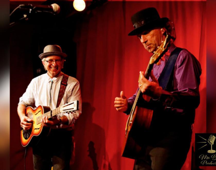 Musicians Tyzack & Tortora in front of a red curtain