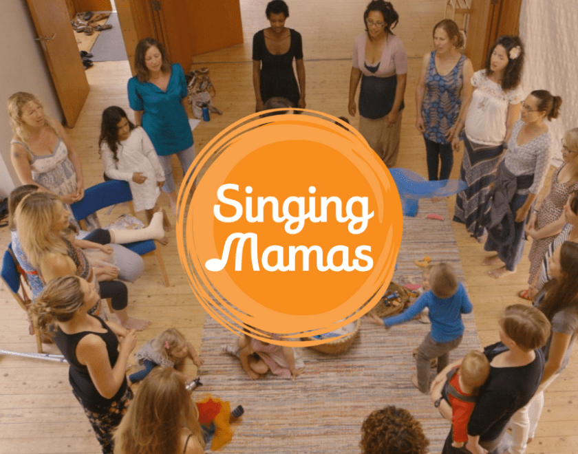 Image of women singing in a circle and Singing Mamas logo