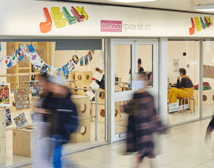 Jelly shop front with blurred images of people walking past