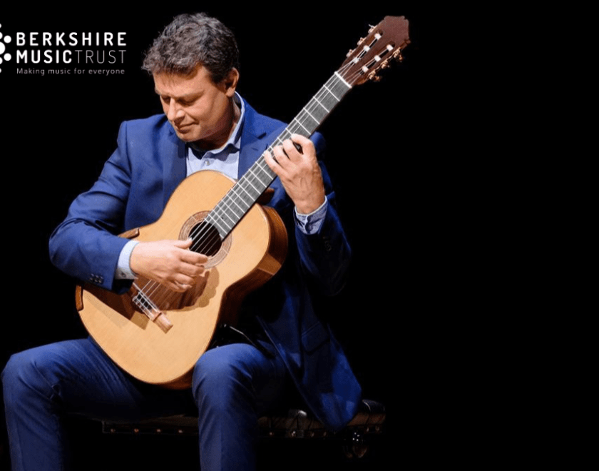 Craig Ogden holding a guitar on a black background and the Berkshire Music Trust logo