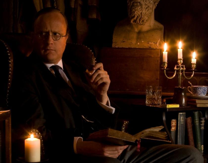 Robert Lloyd Parry as M R James in a candlelit study