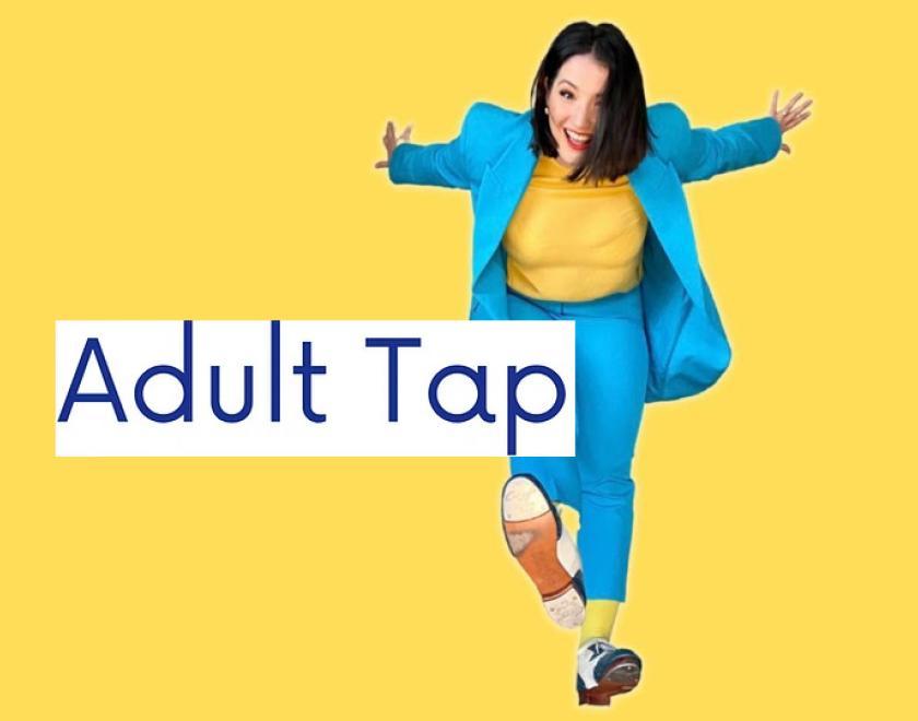 A woman in a bright blue suit posing and showing off her tap shoes