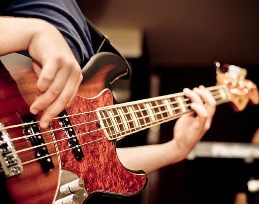 student playing an electric bass