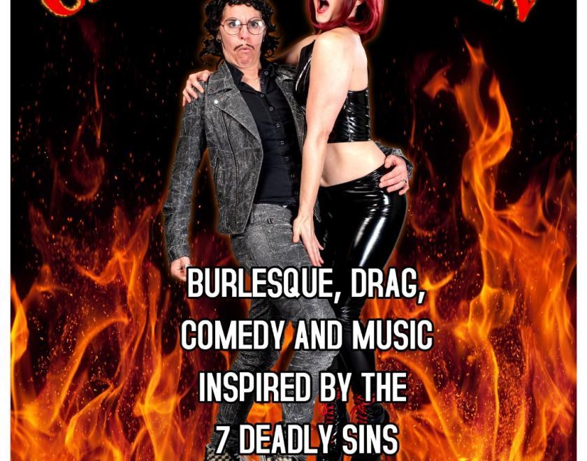 Drag King and burlesque performer in front of some images of flames