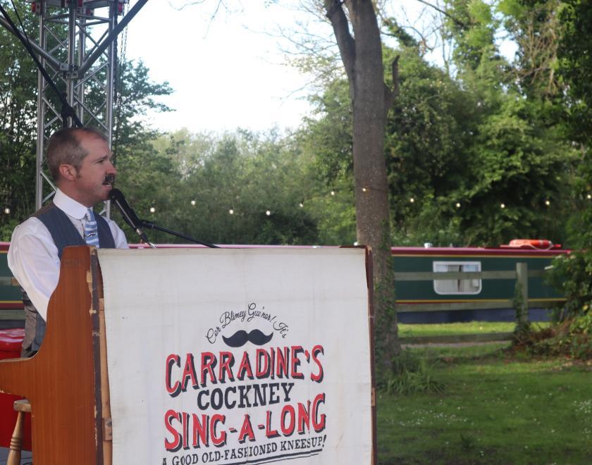 Tom Carradine sitting at a piano