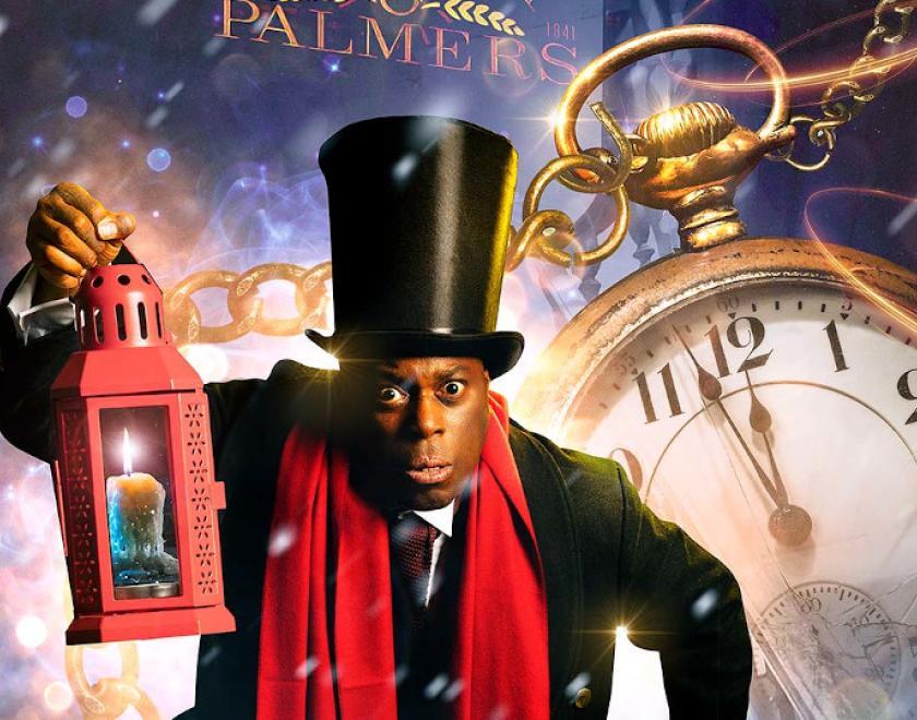 Image of actor playing Ebineezer Scrooge in front of a pocket watch for A Christmas Carol by Reading Rep