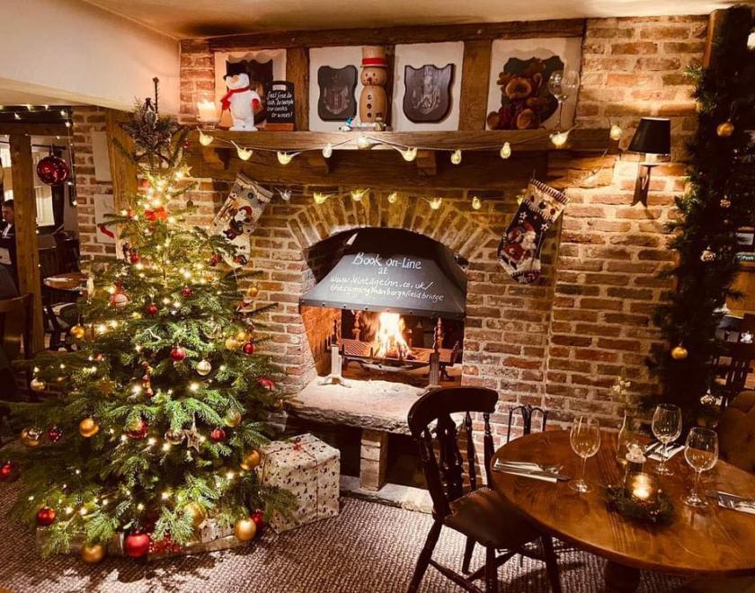 Christmas tree by a wood fire in the Cunning Man pub