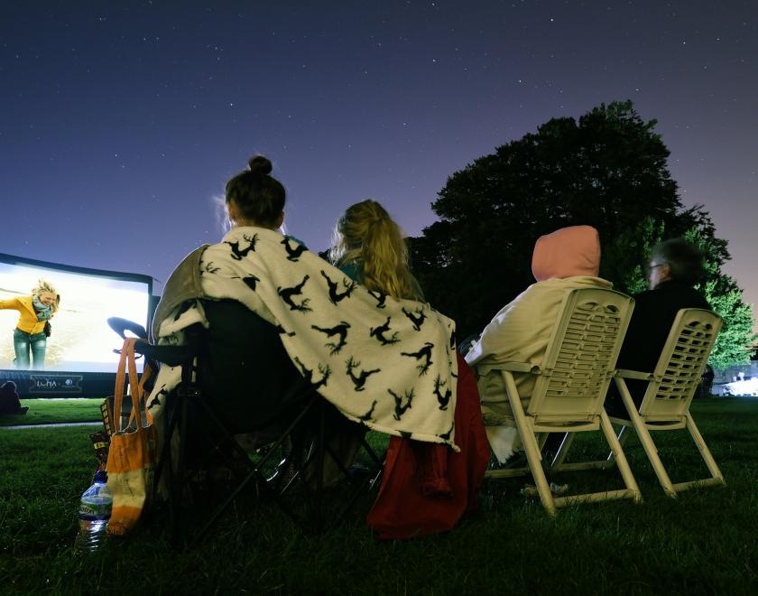 People watching outdoor cinema at Basildon Park