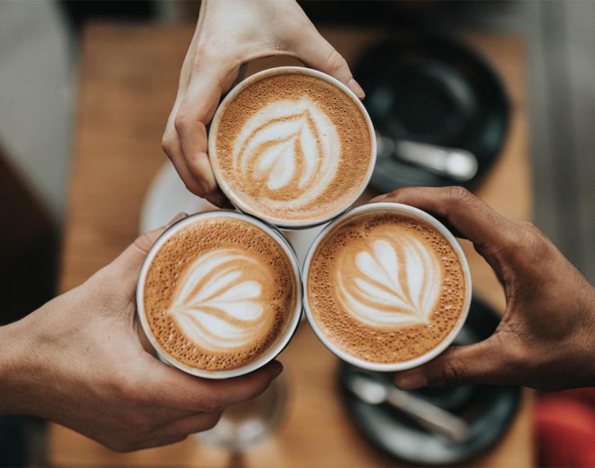 People holding hot drinks