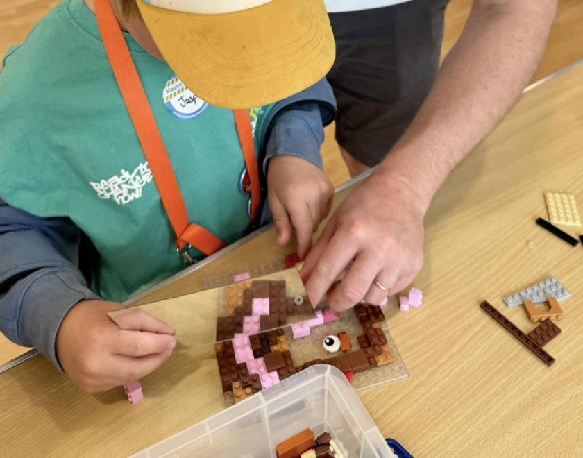 Parent and child building with LEGO