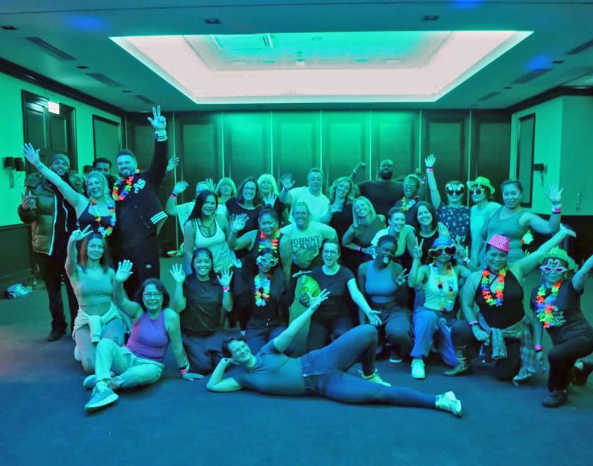 Dance class participants in a big group pose
