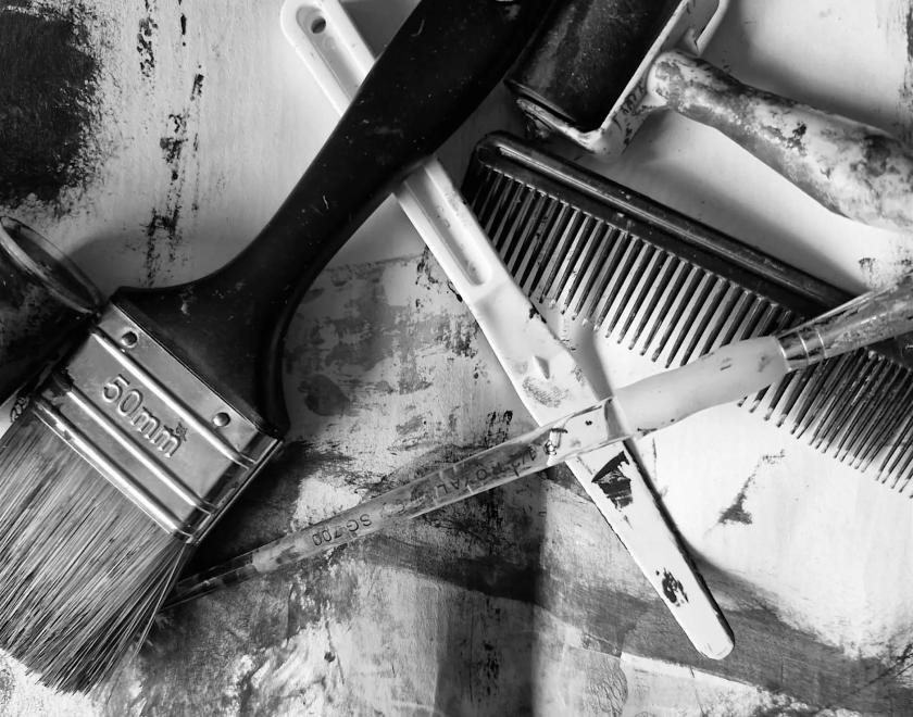 Black and white photo of art equipment - paintbrushes, clay tools and the like