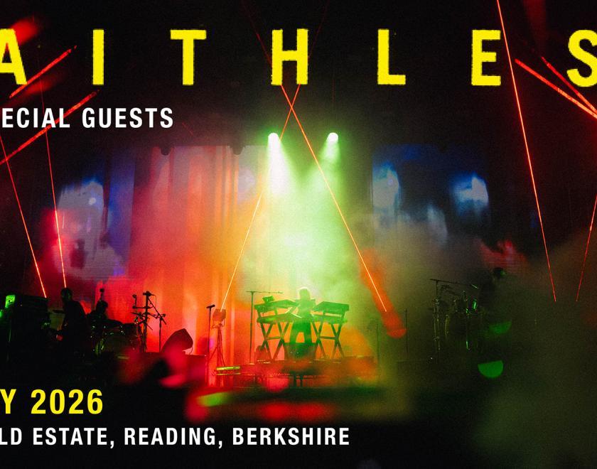 Faithless performing on stage with a massive light show