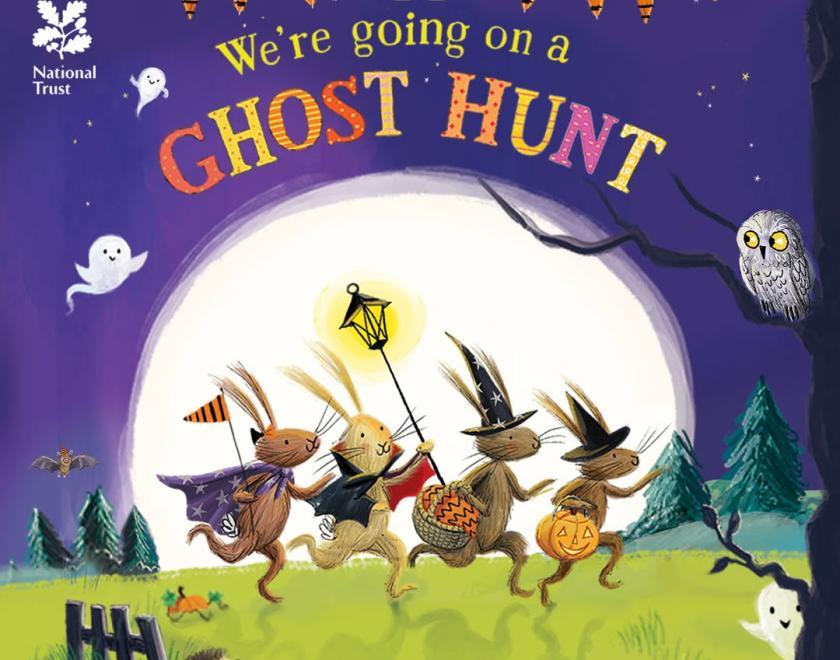 Illustrated book cover of "We’re Going on a Ghost Hunt" with animals in Halloween costumes walking in front of a giant moon