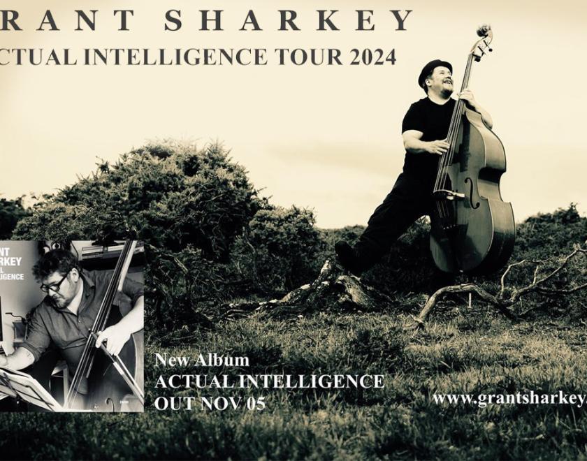 grant sharkey in a pork pie hat and black clothes holding a double bass