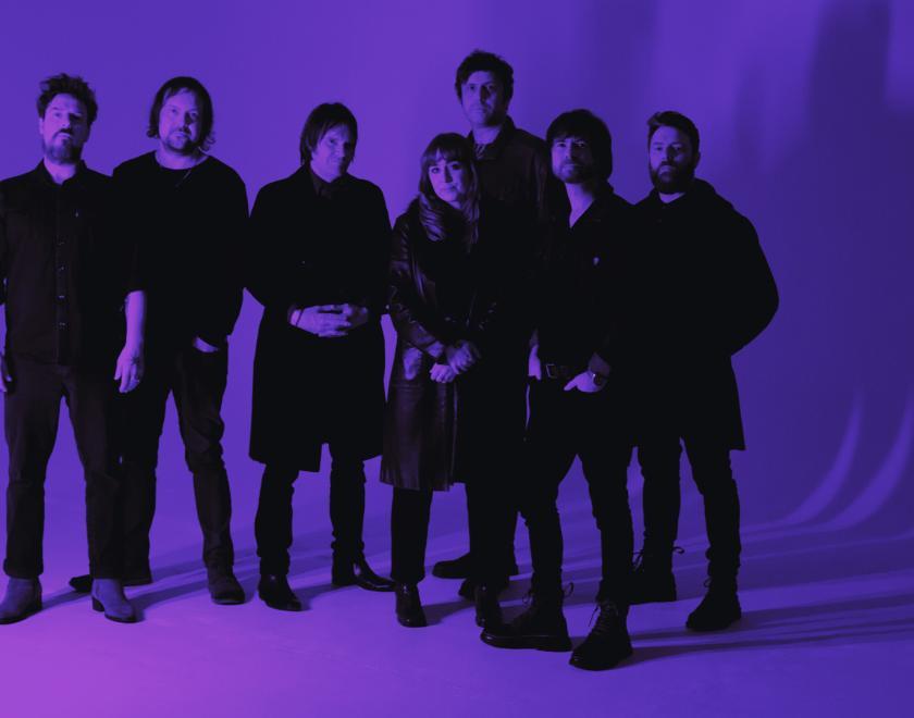 Purple monochrome photo of the band Helicon