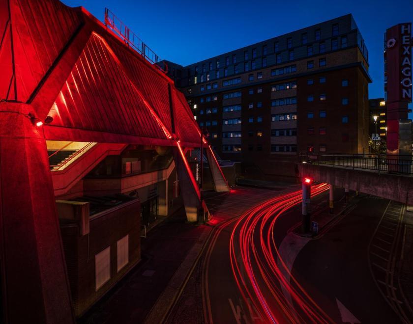 Reading Hexagon at night, lit up in red lights