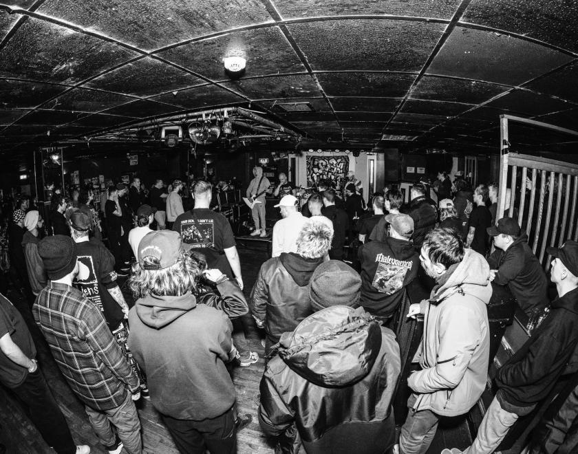 black and white image of a crowd at The FaceBar watching a band on stage