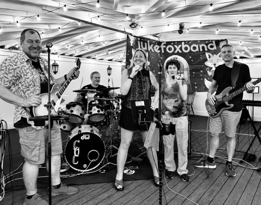 Photos of the five members of Jukfox, each playing their respective instruments