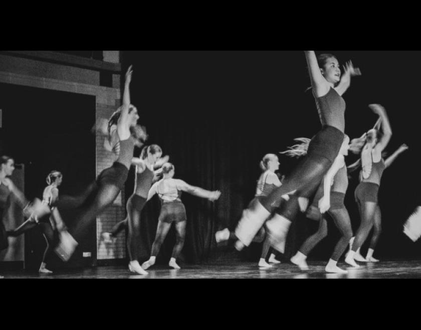 black and white photo of several young female dancers jumping