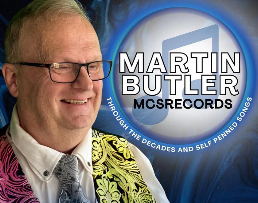 Martin Butler wearing a bright patterned waistcoat and tie