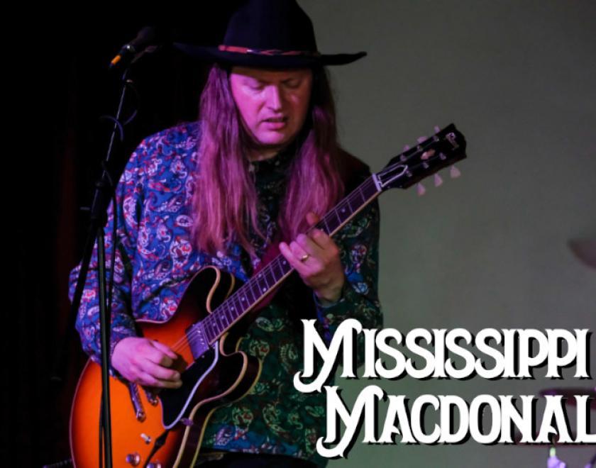 Mississippi MacDonald playing guitar