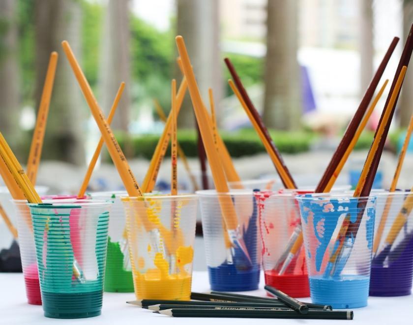 paintbrushes in paint pots.