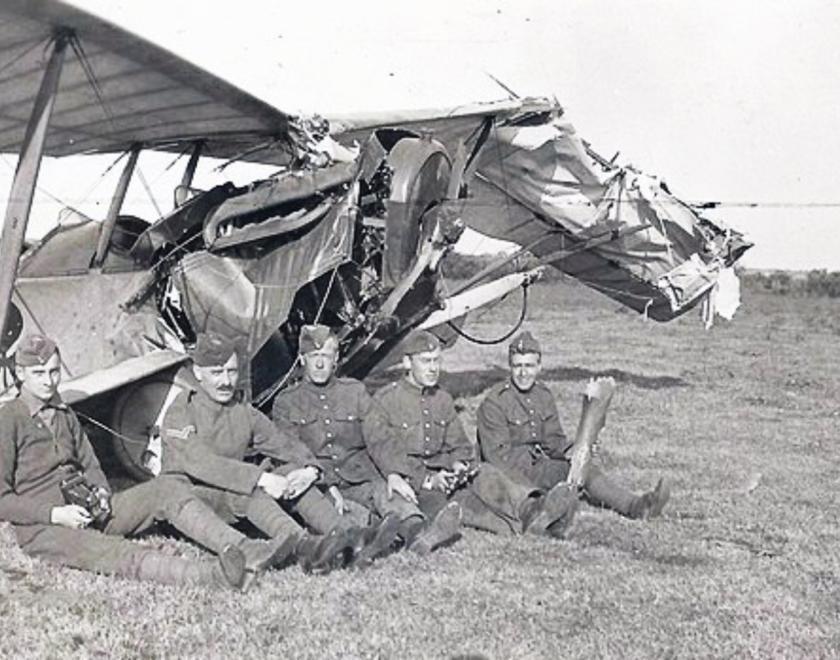 Royal Flying Corps Airmen sitting by their plane