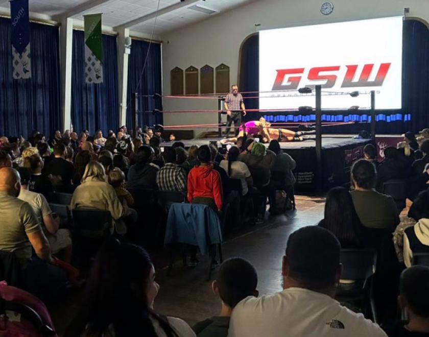 Wrestling match and crowd at Prospect Kings Academy school