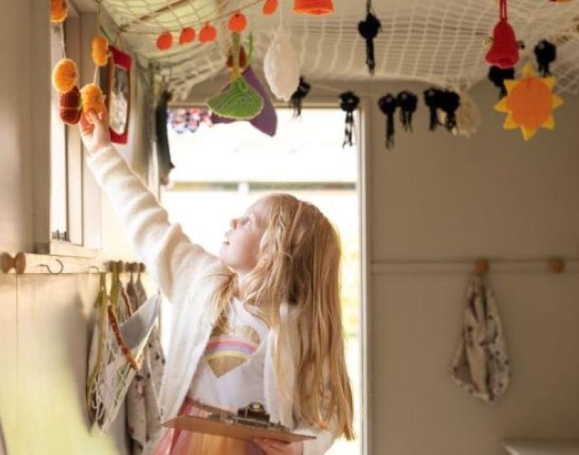 Girl looking at decorations in the Shepherd's Hut at The MERL