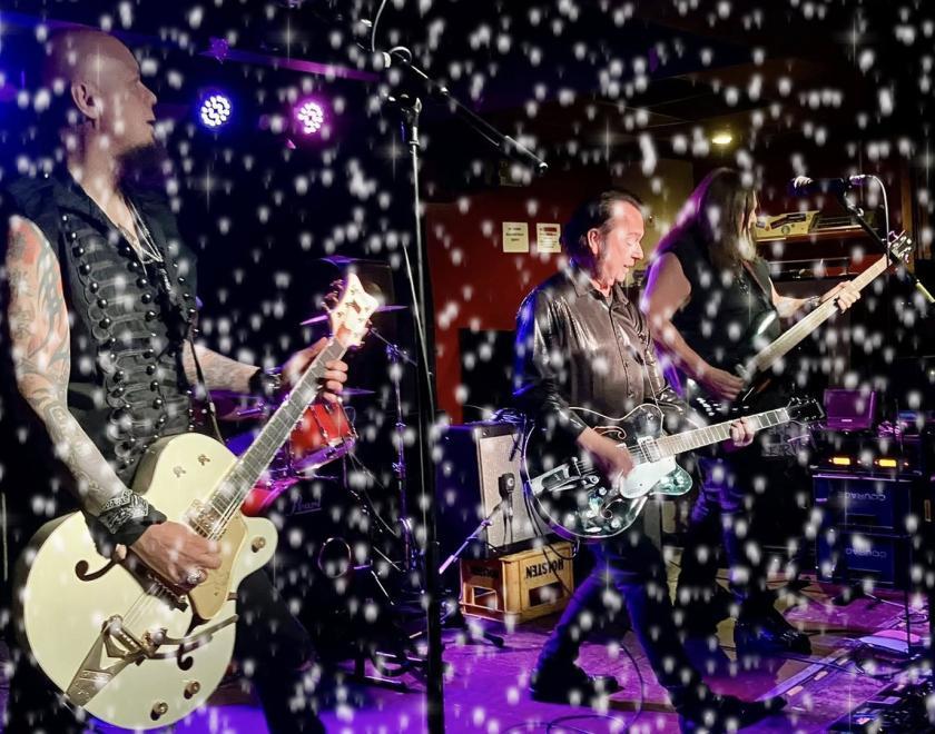 The Go Go Cult on stage, with a snow filter over the top