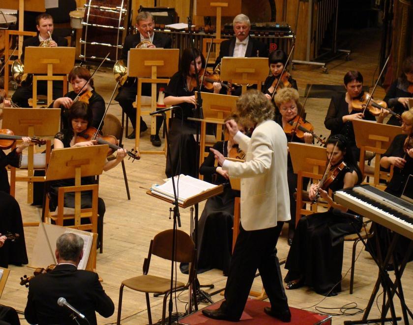 Orchestra with a conductor in a white dinner jacket