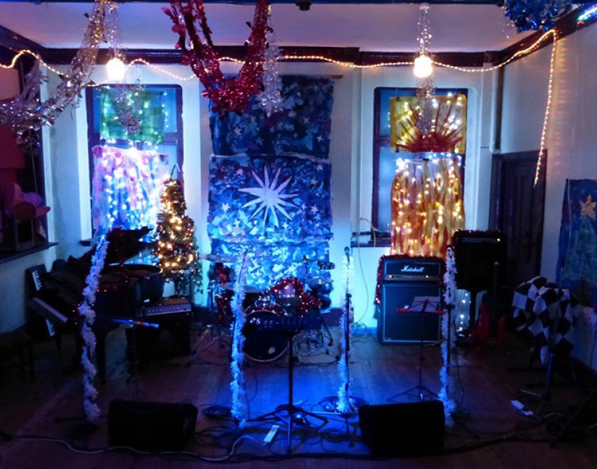 instruments and amps covered in Christmas decorations at the Rising Sun Arts Centre