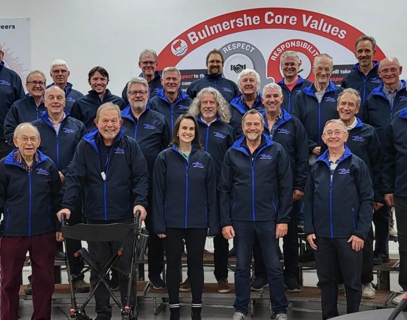 Members of Thames Valley Chorus in matching jackets on stage
