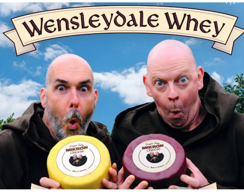 Event poster with two balding actors holding wheels of cheese
