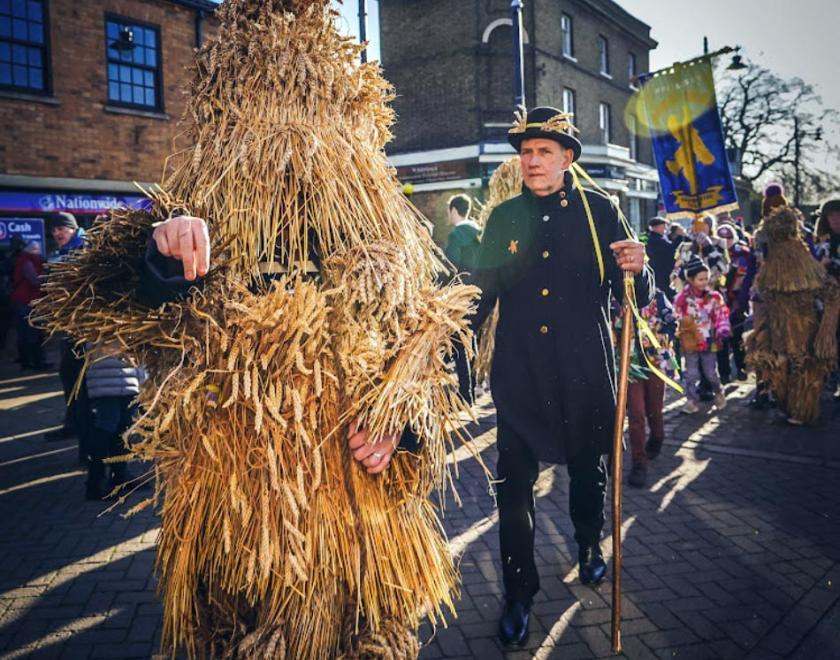 A Whittlesey Straw Bear parading down the street