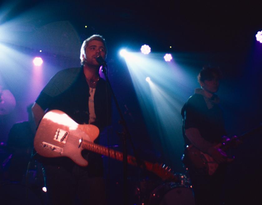 Yasha 96 live, with colourful stage lights behind